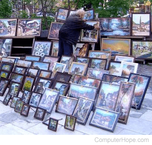 Large arrangement of photographs or paintings in frames.