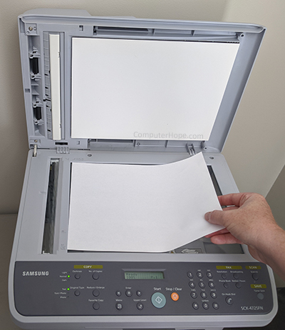 Placing paper on a scanner flatbed.