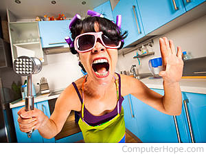 Woman holding a meat tenderizer screaming.