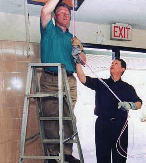 President Bill Clinton and Vice President Al Gore installing networking cables.