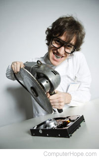 Person using a saw on a hard drive.