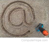At symbol drawn in the sand.