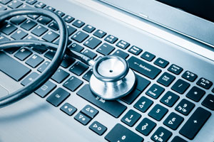 Stethoscope on a laptop.