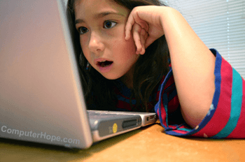 Parent over shoulder of girl on computer