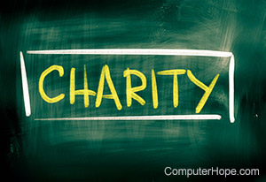 Charity written on a chalkboard with yellow chalk.