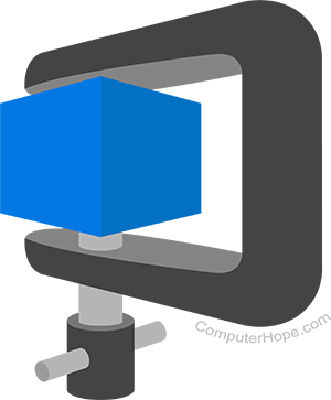 Metal clamp holding and compressing a green cube