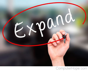 Hand circling the word Expand in red marker.