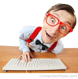 Computer geek with red glasses on keyboard.