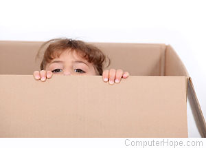 Child peaking out from a cardboard box.
