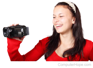 Person holding a video camera.